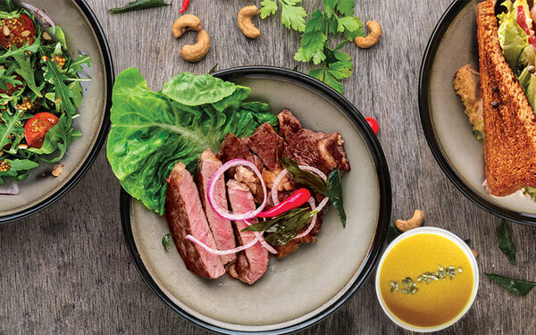 Toasted bread with avocado, herbs and seeds on a plate